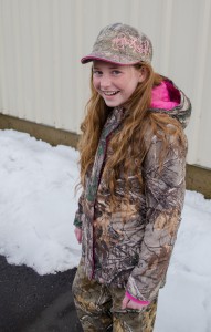 Emileigh wearing girls' camo jacket with pink hood and Browning camo hat